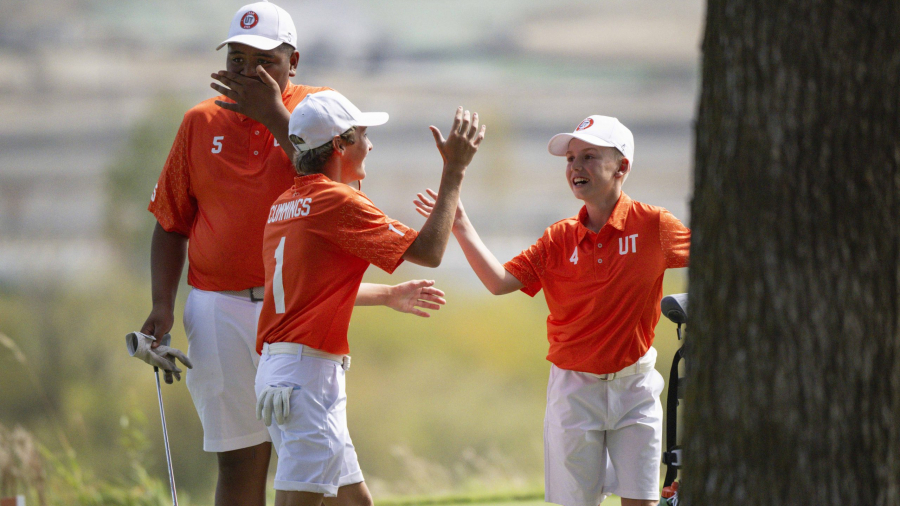 FRISCO, TX - OCTOBER 11: Jraice Finau, Cove Cummings, and Emery Johnson of Team Utah high five during the 2024 JR League Championship at PGA Frisco on Friday, October 11, 2024 in Frisco, Texas. (Photo by Ryan Lochhead/PGA of America)